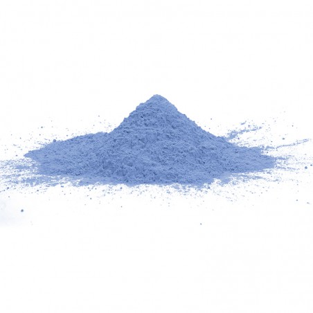 A conical mound of light blue powder rests on a white surface, spreading outward slightly at the base.