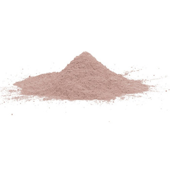 A small conical pile of pink powder rests on a white surface, with scattered particles surrounding it.