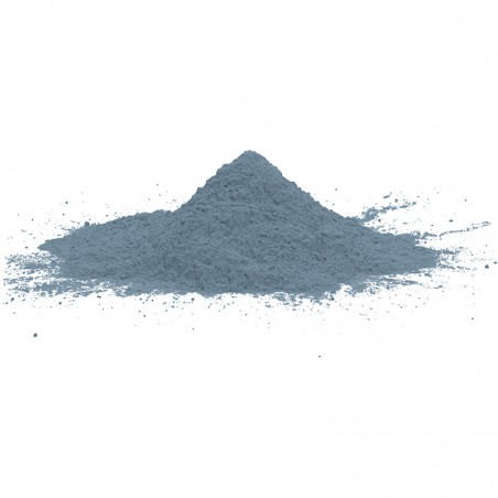 A pile of blue-gray powder rests undisturbed on a plain white surface.