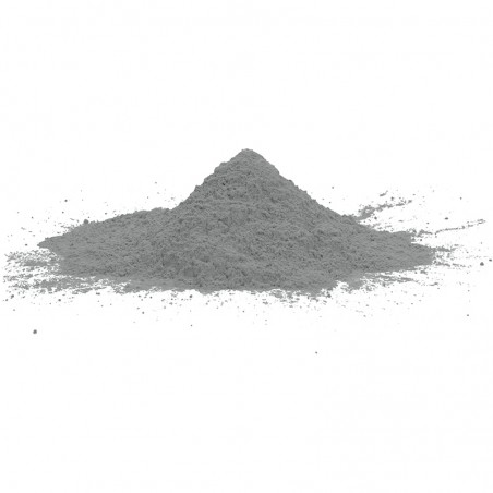 A mound of fine grey powder sits on a plain white background, scattered slightly around its base.