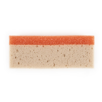 A rectangular cleaning sponge features a coarse orange scrubbing side atop a beige absorbent layer, set against a plain white ba