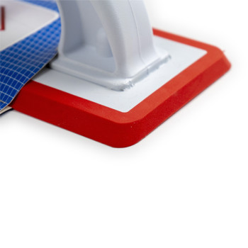 A red and white grouting trowel is attached to a blue packaging card. Text includes: `COLOTOOL LLANA DE REJUNTE PRO PRO GROUTING