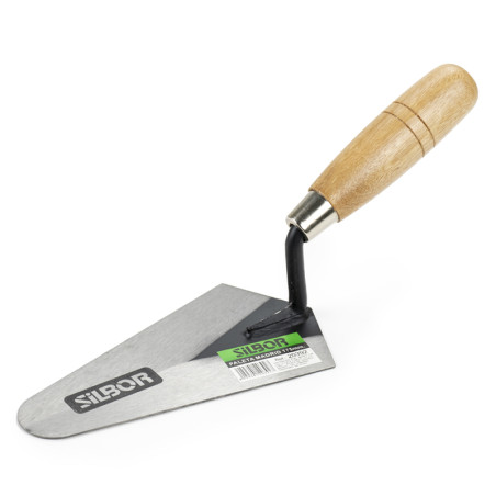 A metal masonry trowel with a wooden handle lies on a white surface. The trowel blade has text: `SIBOR` and a label reads `SIBOR
