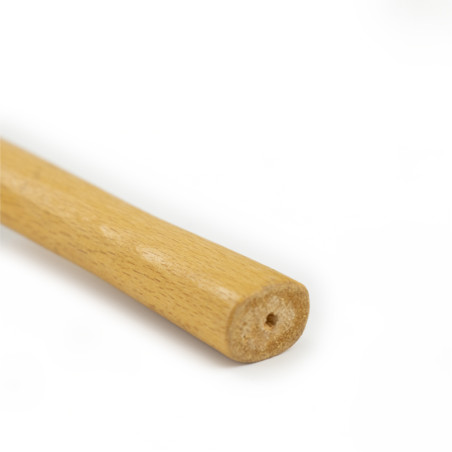 A wooden stick rests on a white background, featuring a smooth cylindrical shape and a small hole at the visible end.