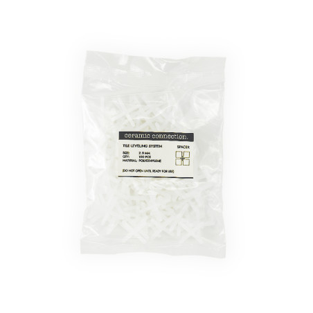 A sealed plastic bag contains white tile leveling spacers. The label reads: `ceramic connection, TILE LEVELING SYSTEM, SPACER, S