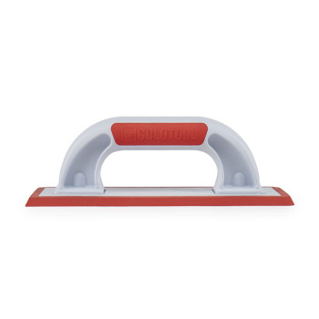 A white rectangular handheld grout float rests on a clear surface, featuring a red ergonomic grip and a red rubber smoothing edg