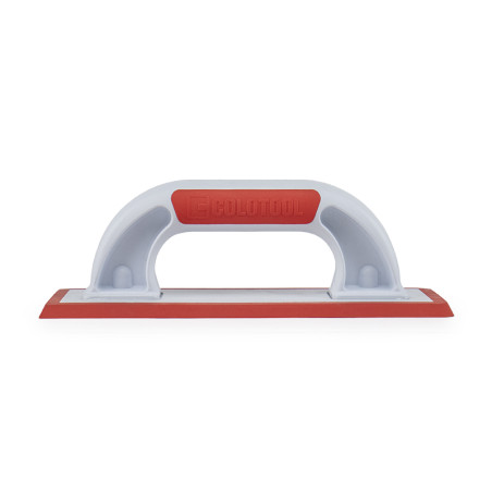 A white rectangular handheld grout float rests on a clear surface, featuring a red ergonomic grip and a red rubber smoothing edg