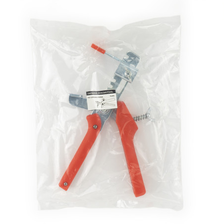 Un outil en métal avec des poignées rouges est emballé dans un emballage en plastique transparent. Une étiquette indique : « TRA