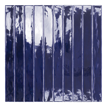 Eine lange, schmale, glänzende marineblaue Fliese steht vertikal und reflektiert Licht vor einem schlichten weißen Hintergrund.
