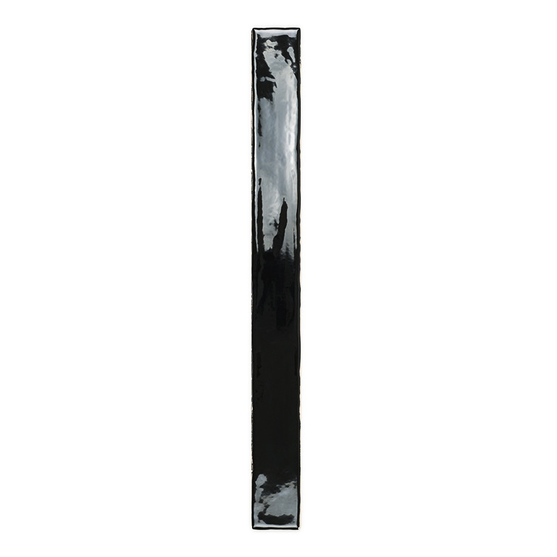 A glossy black, narrow rectangular tile stands vertically, reflecting light, set against a plain white background.