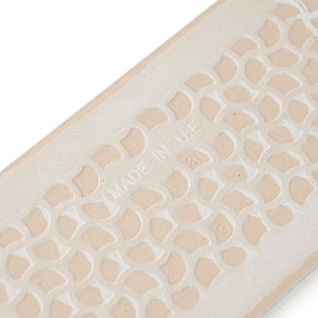 A beige, rectangular tile displays a repeating geometric pattern. `MADE IN U.E.` is embossed centrally, suggesting manufacturing