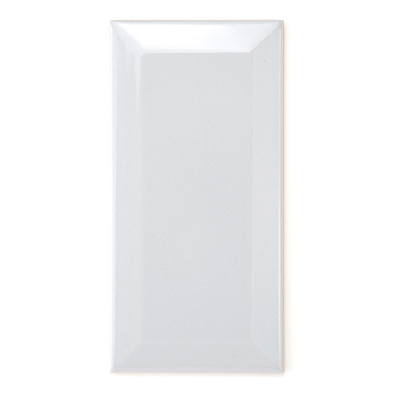 A glossy white rectangular tile reflects light, emphasizing its smooth surface, with slightly beveled edges, set against a plain