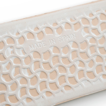 Los azulejos con patrón entrelazado en relieve y con la palabra `MADE IN SPAIN` en relieve se asientan sobre un fondo texturizad