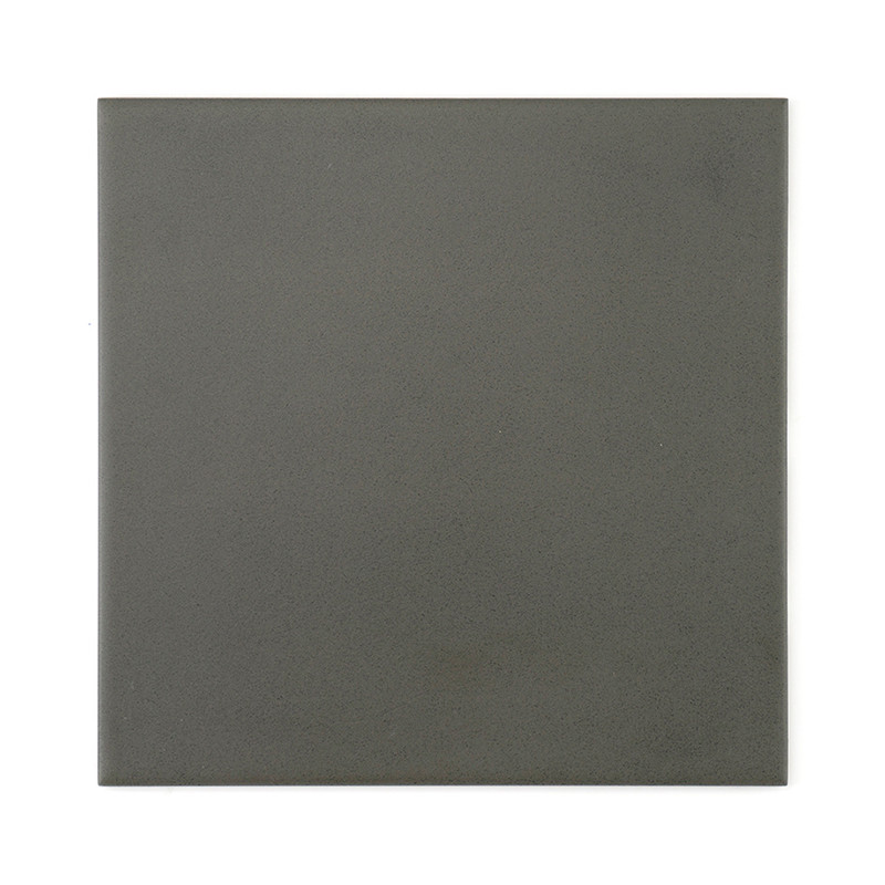 A square, matte dark gray tile lies flat, providing a minimalist and neutral surface, suitable for various interior or exterior 
