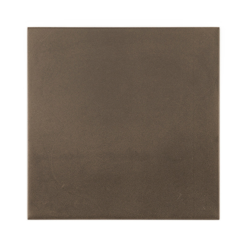 A square, matte, dark brown tile rests on a white background, appearing smooth and uniform in texture, with no visible text.