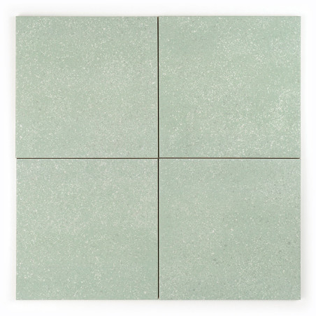 Quatre carreaux carrés vert clair forment une grille transparente, chaque carreau affichant un subtil motif moucheté. Le fond es