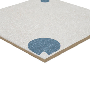 A beige square tile features a large blue semicircle near the corner and a smaller blue dot toward the opposite edge.