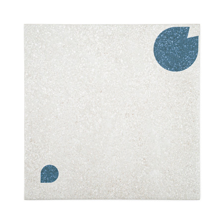 A square tile features two geometric blue shapes, a large circle with a cut-out and a smaller semicircle, on a textured beige ba