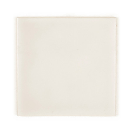 A plain, square ceramic tile rests on a white background, displaying a uniform creamy-white surface with subtle shading variatio