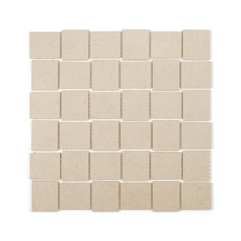 Square beige tiles are arranged in a grid, creating a uniform, textured pattern on a flat surface against a white background.