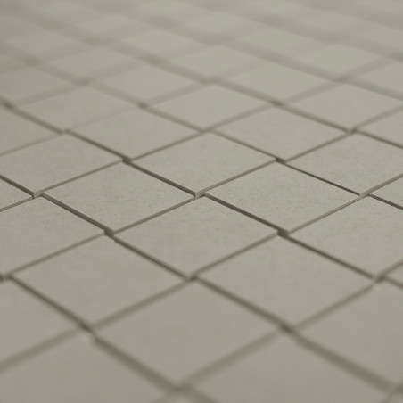 Los azulejos cuadrados grises están dispuestos en un patrón de cuadrícula limpio y repetido sobre una superficie plana, creando 