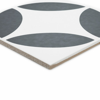 A square ceramic tile features a pattern of four dark gray quarter-circles on a white background, forming a symmetrical design.
