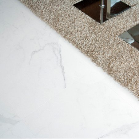 Des carreaux de sol imitant le marbre contrastent avec un tapis beige texturé. Une surface en miroir avec des pieds en métal ref