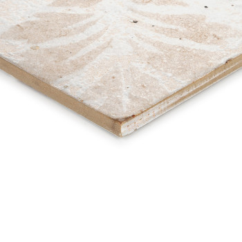 A ceramic tile displays a faded, symmetrical pattern with beige and off-white tones, positioned against a plain white background
