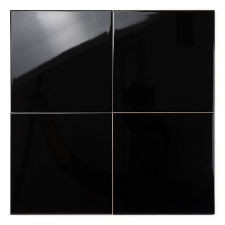 Vier glänzend schwarze Kacheln reflektieren das Licht und sind in einem quadratischen Gittermuster vor einem schlichten weißen H
