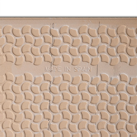 A textured tile displays a repeating pattern of curved shapes. Centered text reads `MADE IN SPAIN,` surrounded by a beige surfac