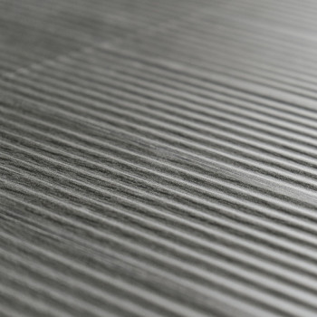 Textured gray tile features parallel raised ridges, creating a striped pattern, on a smooth, even surface.