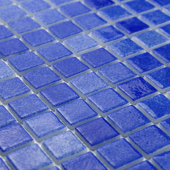 Glazed blue glass tiles arranged systematically, creating a textured, reflective surface in a grid pattern.