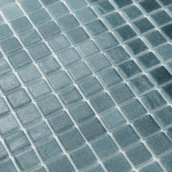 Square glass tiles align neatly, forming a textured pattern. They glimmer subtly, set against a uniform grid layout.