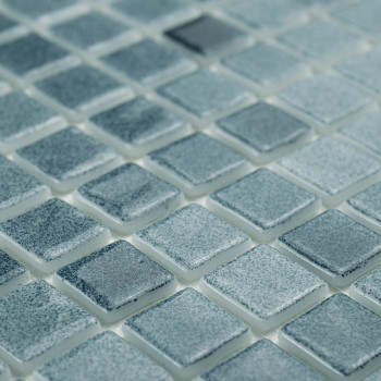 Square glass tiles shimmer subtly, reflecting light across a grid, creating a textured, uniform mosaic pattern.