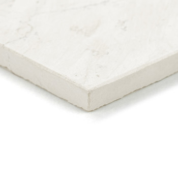 Rectangular stone tile rests on a flat surface, displaying a smooth, light-colored texture with subtle marbling patterns.
