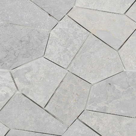 Gray stone tiles, arranged in an irregular geometric pattern, create an interlocking mosaic on building floor or wall.