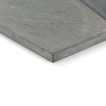 A smooth, rectangular stone tile lies flat, revealing a gray textured surface with subtle patterns, resting on a white backgroun