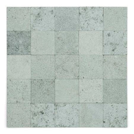 Gray stone tiles form a grid pattern, exhibiting speckles and slight color variation, creating a textured mosaic effect.