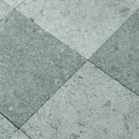Gray stone tiles form a checkered pattern, alternating shades, creating a textured, industrial floor surface.