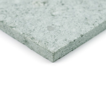 A green stone tile with a textured surface, lying flat against a white background.