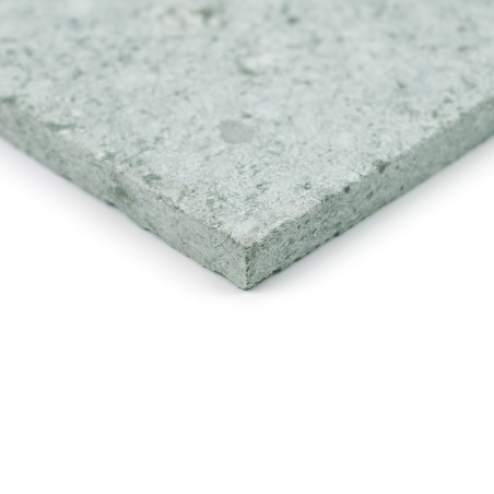 A green stone tile with a textured surface, lying flat against a white background.