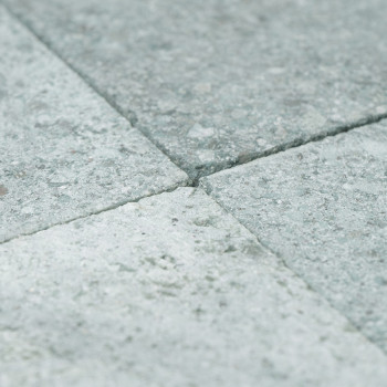 Gray stone tiles form a smooth, textured surface arranged in a neat grid pattern.