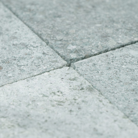 Gray stone tiles form a smooth, textured surface arranged in a neat grid pattern.