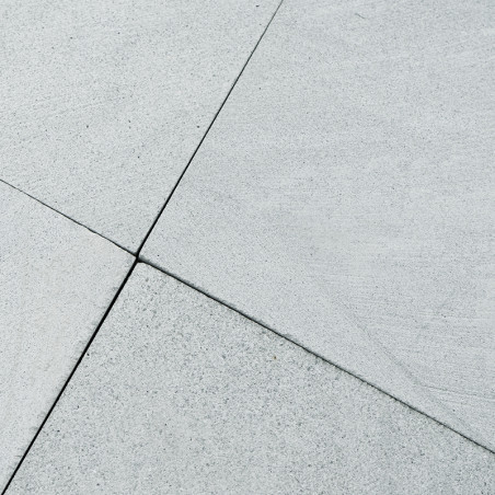 Gray stone tiles intersect seamlessly, forming a clean grid pattern, suggesting a modern outdoor or indoor flooring setting.