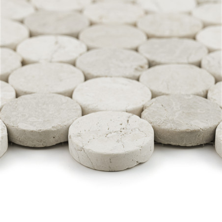 Circular stone tiles arranged closely together, forming a cohesive, textured surface in a uniform, light gray color.