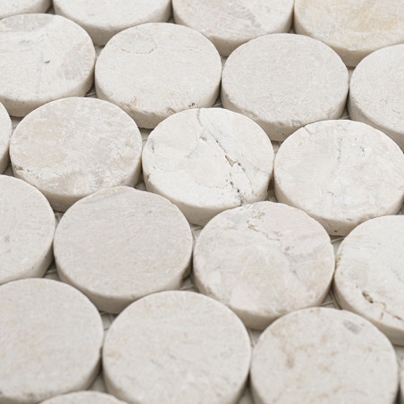 Round stone tiles are arranged closely together, forming a textured, seamless surface. The context is a uniform background.