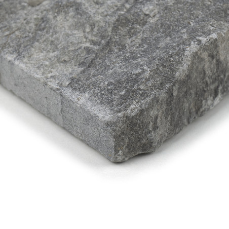 Gray stone tile, resting on a flat surface, features a rough, textured surface with various shades of gray.