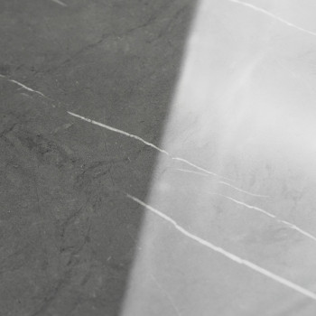 The tile features a smooth surface divided diagonally. one side is dark gray, the other is light gray, both with subtle white ve