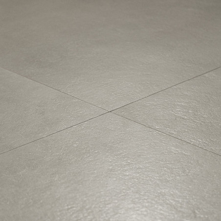 azulejos de cerámica gris colocadas planas con una superficie texturizada sutil, que se cruzan con líneas de lechada formando un