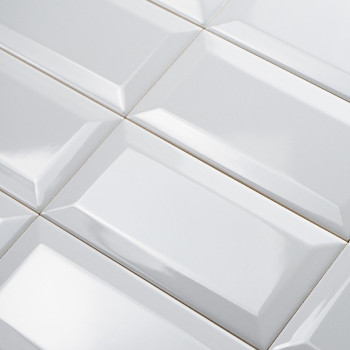 White rectangular tiles arranged in a grid, featuring a glossy, beveled surface that reflects light in a uniform pattern.